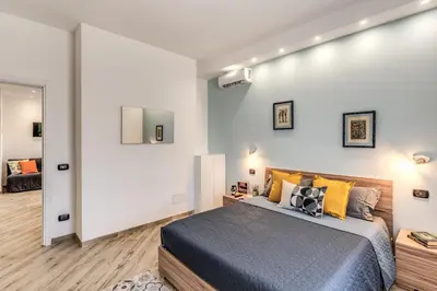 a bedroom with a king sized bed and a mirror at Appartamento Roma metro C Greghouse Centocelle in Rome