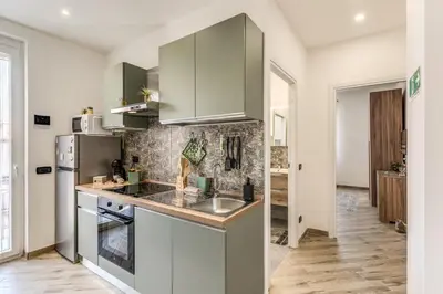 a kitchen with a sink and a refrigerator at Appartamento Roma metro C Greghouse Centocelle in Rome