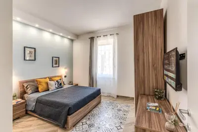 a bedroom with a king sized bed and a television at Appartamento Roma metro C Greghouse Centocelle in Rome