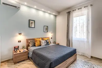 a bedroom with a large bed and a window at Appartamento Roma metro C Greghouse Centocelle in Rome
