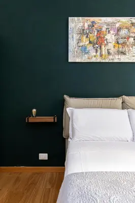 a bedroom with a bed with a painting on the wall at Beautiful Apartment Rome Vaticano in Rome