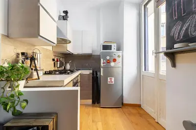 a kitchen with a stainless steel refrigerator and a window at Beautiful Apartment Rome Vaticano in Rome
