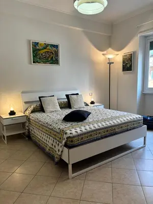a bedroom with a bed and two tables and a lamp at PR - appartamento in centro a Roma in Rome