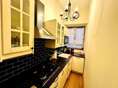a kitchen with a black and white counter top at Benedetta house Trastevere in Rome