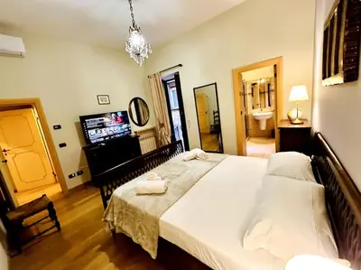 a bedroom with a large bed and a television at Benedetta house Trastevere in Rome