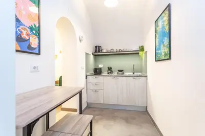 a kitchen with a table and a counter top at Pantheon Giovanni Hideaway in Rome