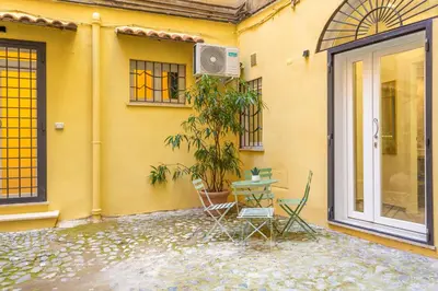 a table and chairs sitting outside of a house at Pantheon Giovanni Hideaway in Rome