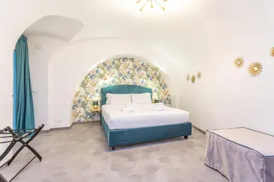 a bedroom with a bed with a blue headboard at Pantheon Giovanni Hideaway in Rome