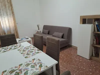 a living room with a couch and a table at Mauri's Home - CasaMauri - Adiacente Metro C in Rome