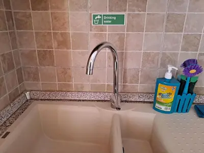 a sink with a faucet in a kitchen at Mauri's Home - CasaMauri - Adiacente Metro C in Rome