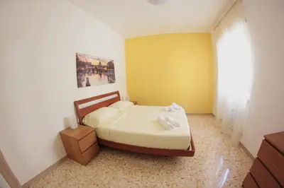 a bedroom with a bed and a yellow wall at Mauri's Home - CasaMauri - Adiacente Metro C in Rome
