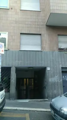 an entrance to a building with a car parked in front at Valle Aurelia House in Rome