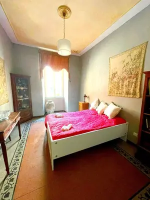a bedroom with a bed with a pink comforter at Vatican Mamma Roma in Rome