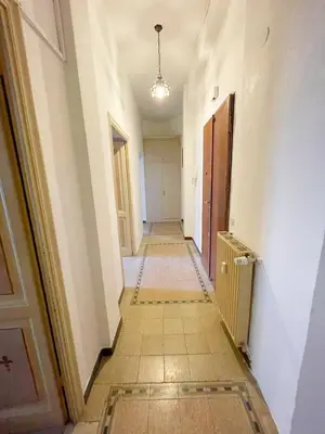 a long hallway with a tile floor in a building at Vatican Mamma Roma in Rome
