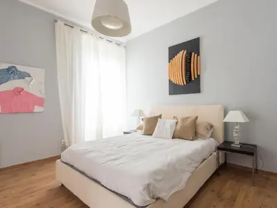 a white bedroom with a large bed and a window at Apartment La Casa dell'Arte by Interhome in Rome