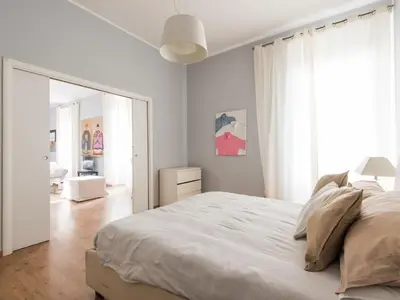 a white bedroom with a large bed and a mirror at Apartment La Casa dell'Arte by Interhome in Rome