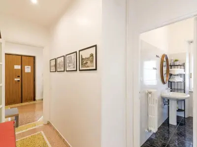 a white hallway with a sink and a mirror at Apartment Appartamento Renato Roma Musei Vaticani by Interhome in Rome