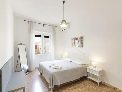 a white bedroom with a bed and a mirror at Apartment Appartamento Renato Roma Musei Vaticani by Interhome in Rome
