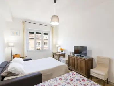 a bedroom with a bed and a tv and a couch at Apartment Appartamento Renato Roma Musei Vaticani by Interhome in Rome