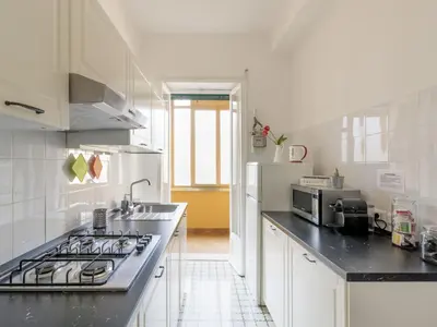 a white kitchen with a stove and a sink at Apartment Appartamento Renato Roma Musei Vaticani by Interhome in Rome