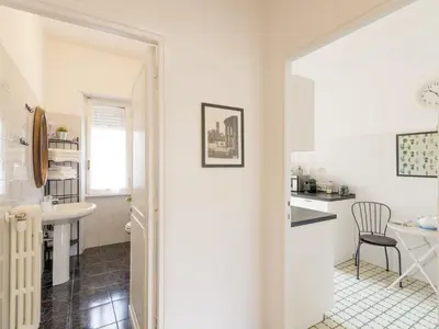 a white bathroom with a sink and a table at Apartment Appartamento Renato Roma Musei Vaticani by Interhome in Rome