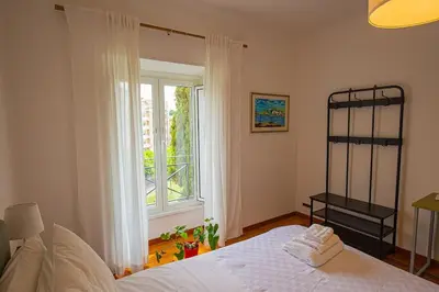 a bedroom with a bed and a large window at Dimora al Colosseo, 2 bedrooms in Rome