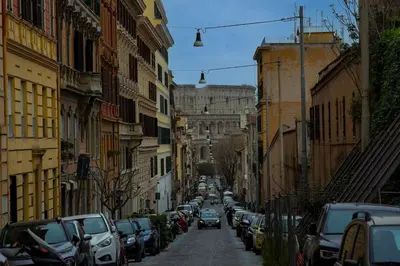 a city street with cars parked on the sides at Dimora al Colosseo, 2 bedrooms in Rome