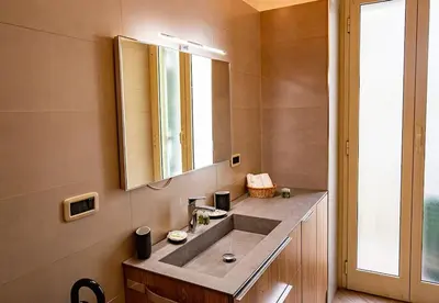 a bathroom with a sink and a mirror at Dimora al Colosseo, 2 bedrooms in Rome