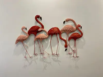 four flamingos standing in a row on a wall at Casa Tua a Roma Centro con box auto tra Stadio Olimpico e Vaticano in Rome