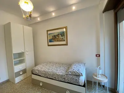 a small bedroom with a bed and a table at Casa Tua a Roma Centro con box auto tra Stadio Olimpico e Vaticano in Rome