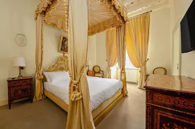 a bedroom with a canopy bed and a desk at YCH-Magnifica residenza a Campo de Fiori in Rome