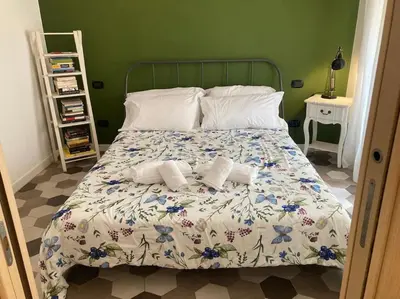 a bedroom with a bed with two towels on it at Garbatella Garden Home in Rome
