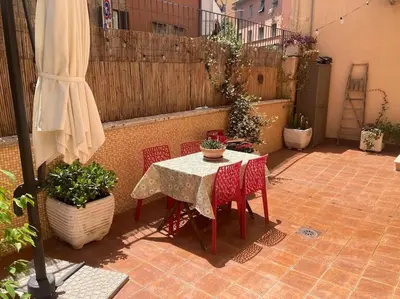 a patio with a table and chairs and a fence at Garbatella Garden Home in Rome
