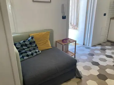 a couch with pillows on it in a room at Garbatella Garden Home in Rome