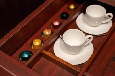 a wooden tray with two cups and plates and candles at The Couper Umiltà in Rome