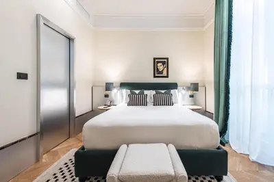 a bedroom with a large white bed and a window at The Couper Umiltà in Rome