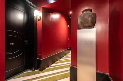 a hallway with red walls and a vase at The Couper Umiltà in Rome