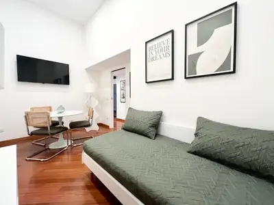 a bedroom with a bed and a desk at Trastevere Wondersuite in Rome