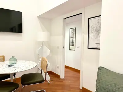 a living room with a table and a chair at Trastevere Wondersuite in Rome