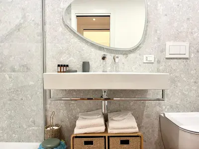 a bathroom with a sink and a mirror at Trastevere Wondersuite in Rome