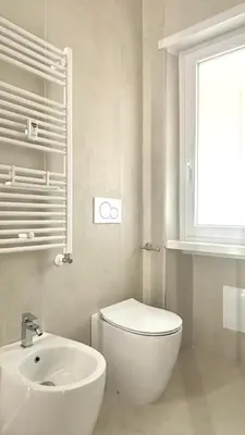 a white bathroom with a toilet and a sink at Vatican Lovely Nights-Luxury Rooms in Rome