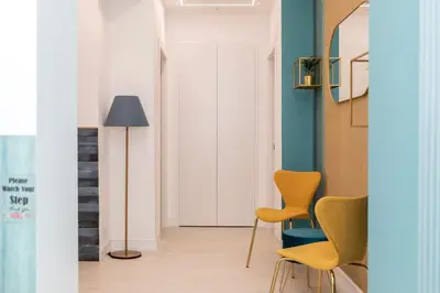 a hallway with yellow chairs and a floor lamp at Vatican Lovely Nights-Luxury Rooms in Rome