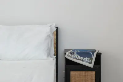 a alarm clock sitting on top of a bed at Palazzo Piazza Cavour-ZEN62 in Rome