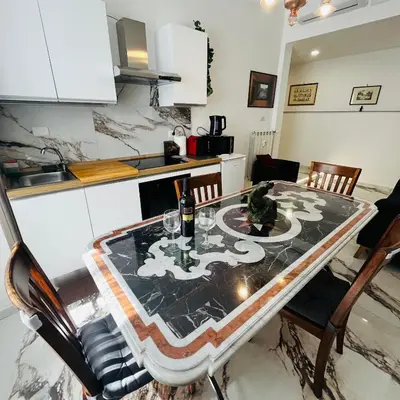 a kitchen with a table with a table cloth on it at Escape to the Eternal City Vatican Stay in Rome