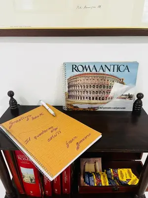 a note on a table with a book and books at Escape to the Eternal City Vatican Stay in Rome