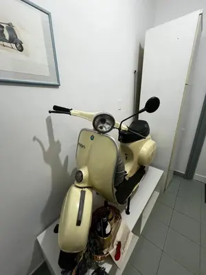 a yellow scooter sitting on a shelf in a room at Escape to the Eternal City Vatican Stay in Rome