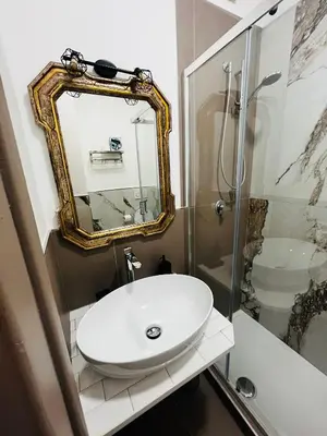a bathroom with a sink and a mirror at Escape to the Eternal City Vatican Stay in Rome
