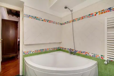 a bathroom with a tub and a toilet at Stunning Pantheon Apartment in Rome