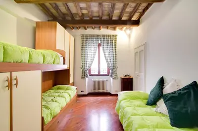 a room with two green beds and a window at Stunning Pantheon Apartment in Rome
