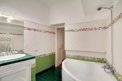 a bathroom with a tub and a sink at Stunning Pantheon Apartment in Rome